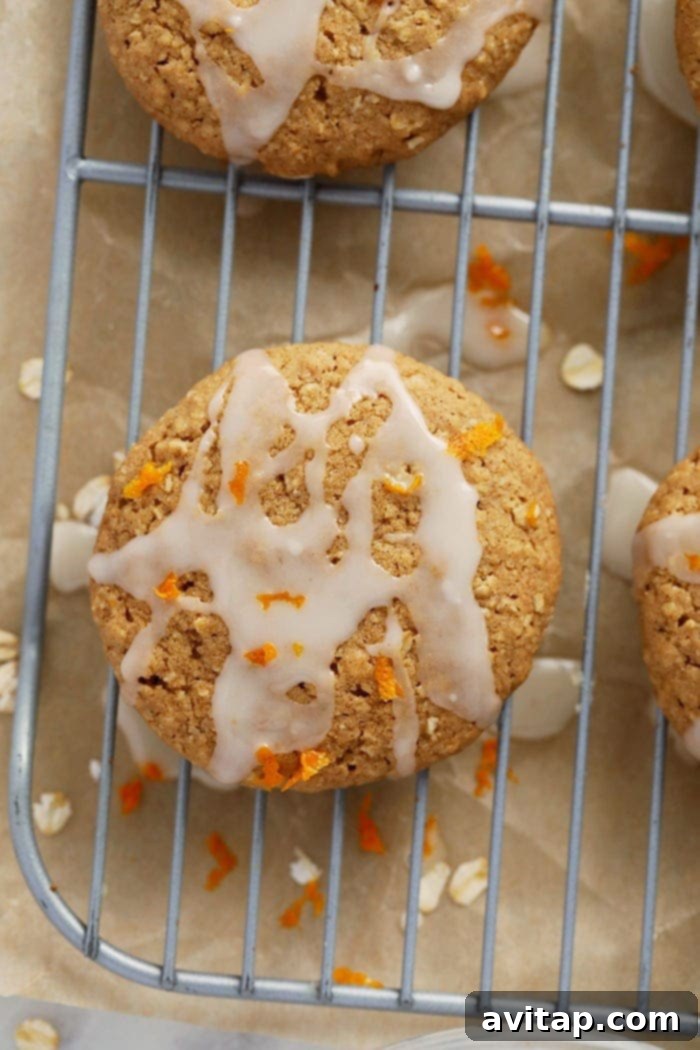 Cooling Rack with a Single Iced Oatmeal Cookie for Perfect Setting A freshly iced oatmeal cookie resting on a wire cooling rack to allow the frosting to set