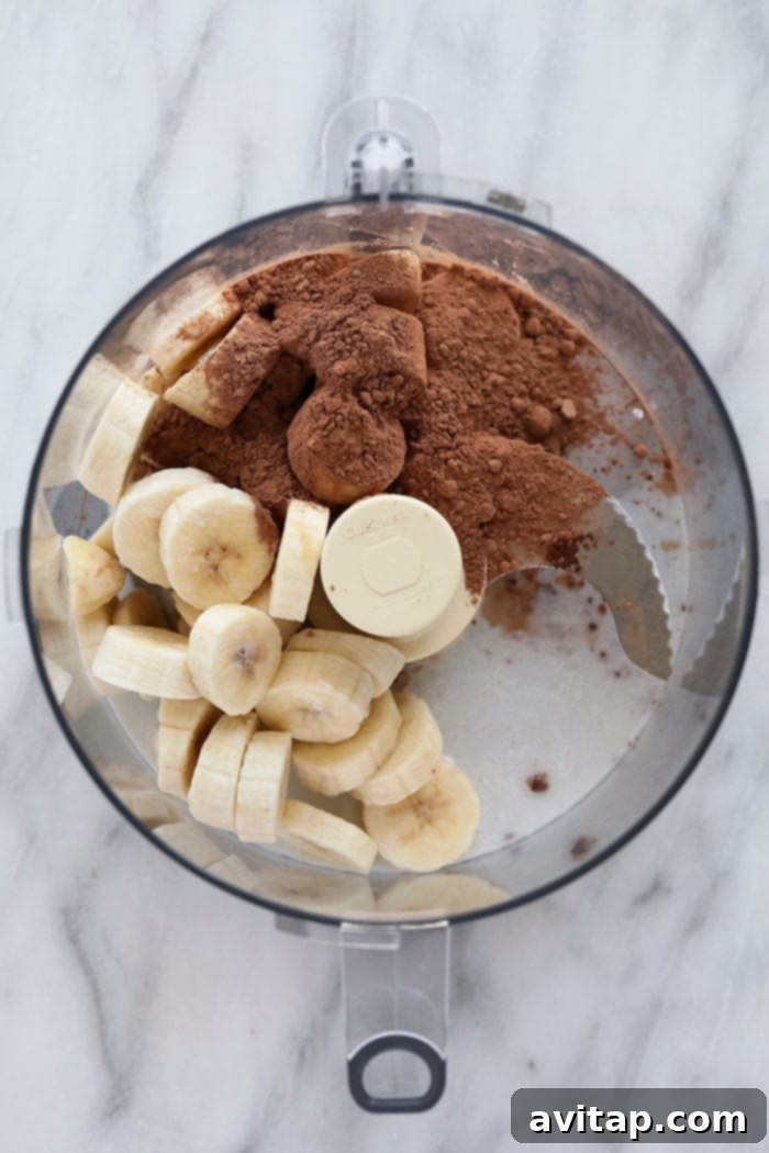 Close-up of a glass filled with smooth, rich Chocolate Peppermint Banana Nice Cream, emphasizing its perfectly chilled, creamy consistency.