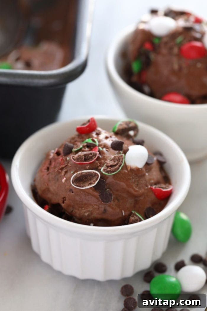 Another enticing view of Chocolate Peppermint Banana Nice Cream in a cup, garnished with an array of mini chocolate chips, emphasizing its delicious texture.