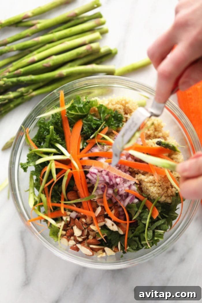 Hands demonstrating the creation of vegetable ribbons from a carrot using a peeler.