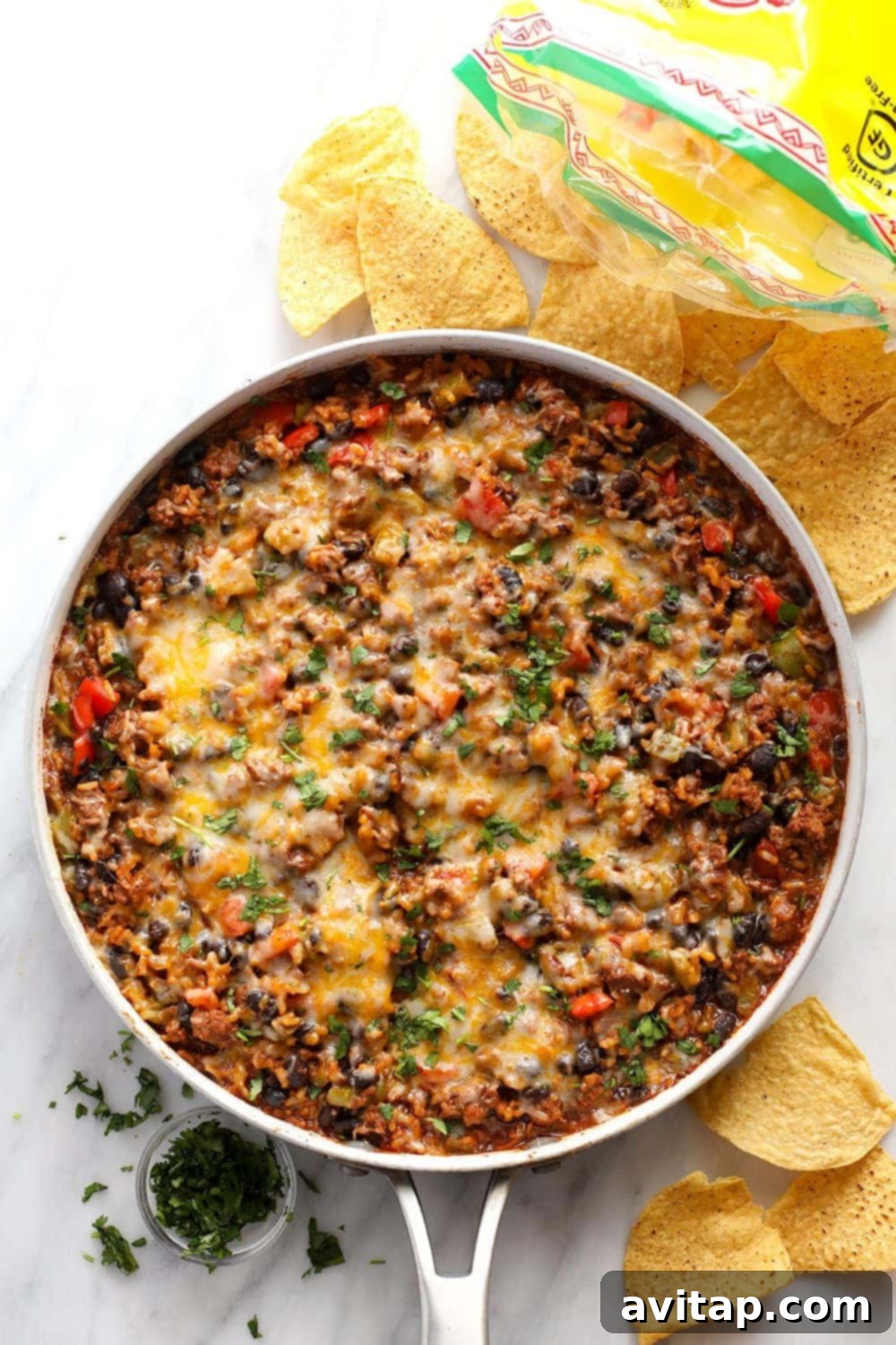 A vibrant Mexican ground beef skillet, freshly cooked and steaming in a large pan, ready to be served.