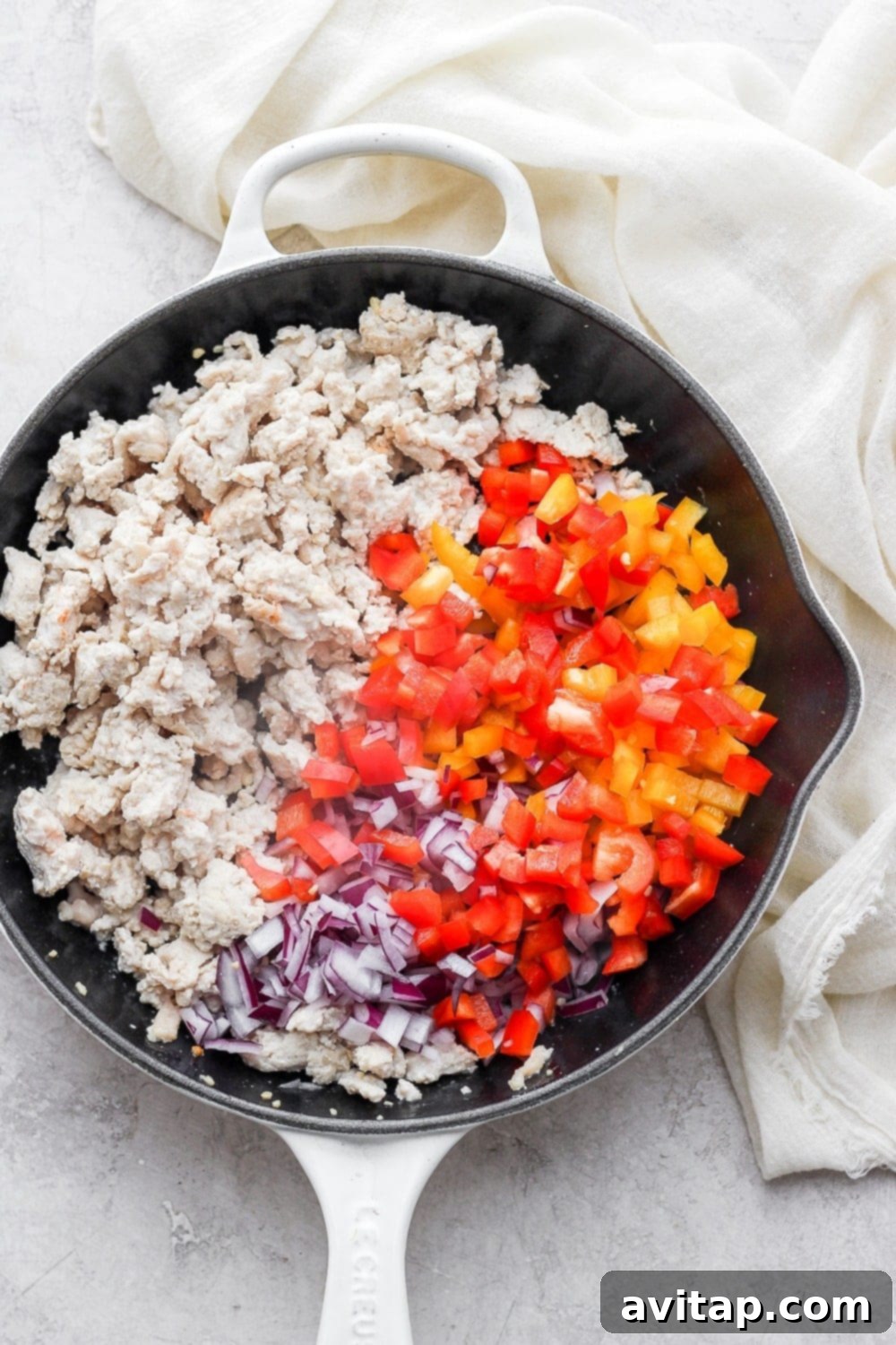 Fresh ingredients laid out for making the lettuce wraps, including ground turkey, bell peppers, onions, and avocado