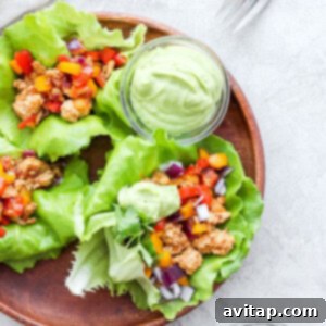 Closeup of a fajita ground turkey lettuce wrap with avocado crema