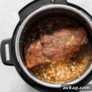 An Instant Pot filled with pulled pork ingredients.