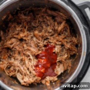 BBQ sauce on pulled pork in Instant Pot.
