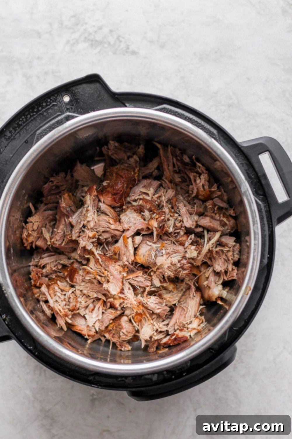 Cooked and shredded pulled pork, perfectly tender in the Instant Pot.