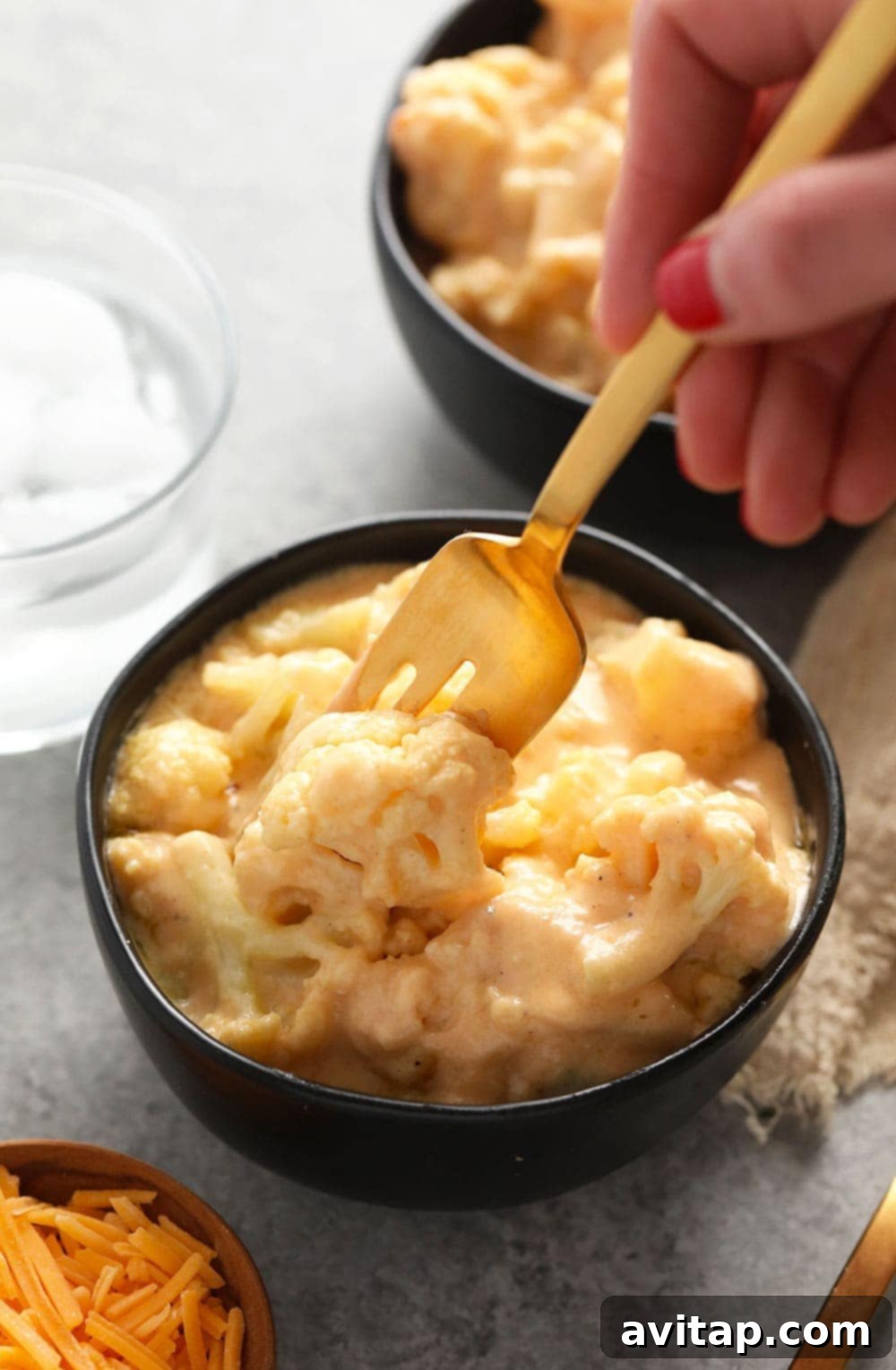 Ultimate Triple Cheese Cauliflower Mac 5 A bowl of hot, bubbling three cheese cauliflower mac and cheese, ready to be enjoyed.
