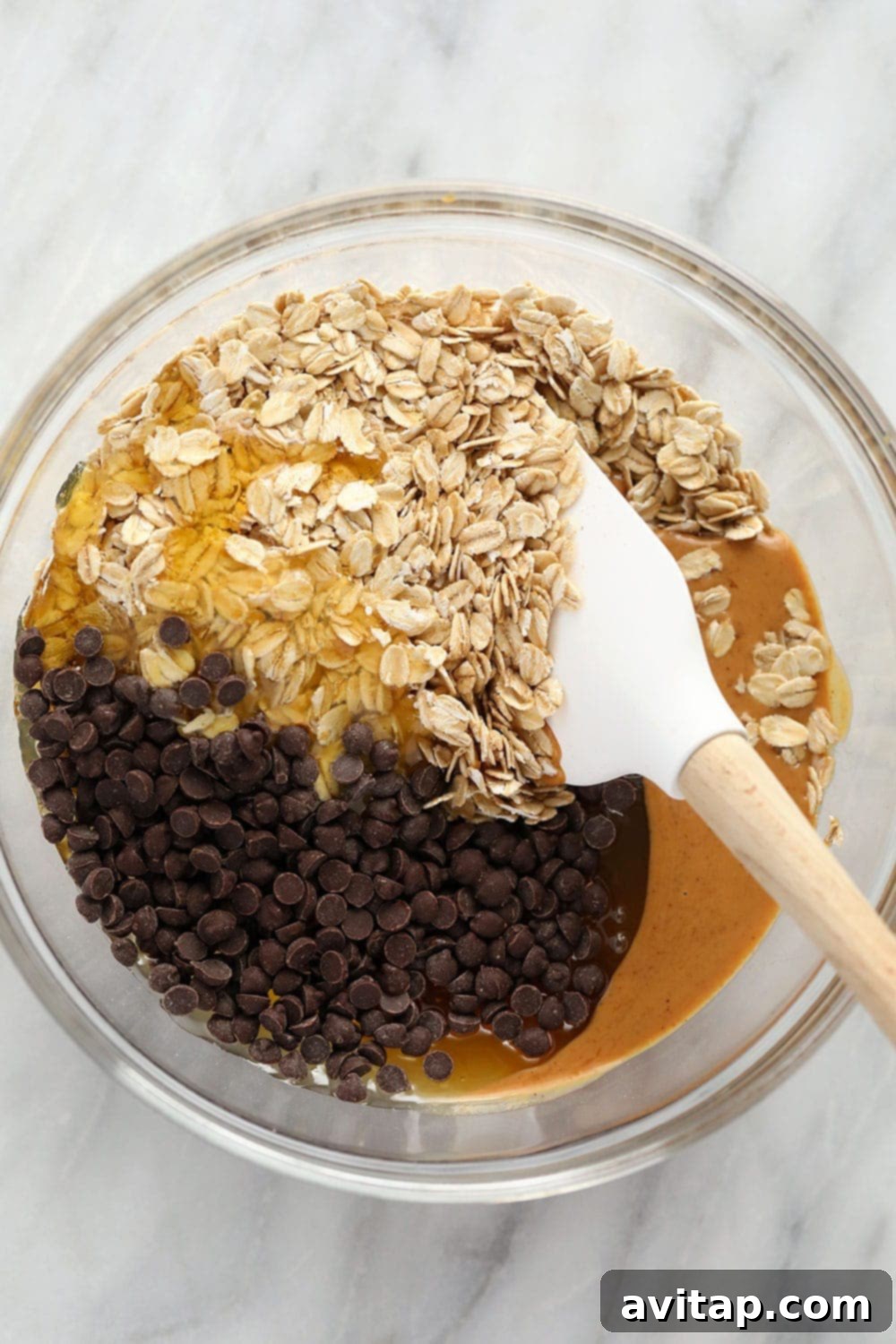 All the wholesome ingredients for no-bake chocolate oatmeal cookies beautifully displayed in a bowl, ready for mixing.
