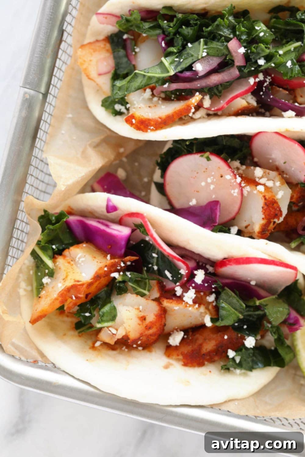Freshly prepared baked fish tacos in a rustic basket, ready to be enjoyed.