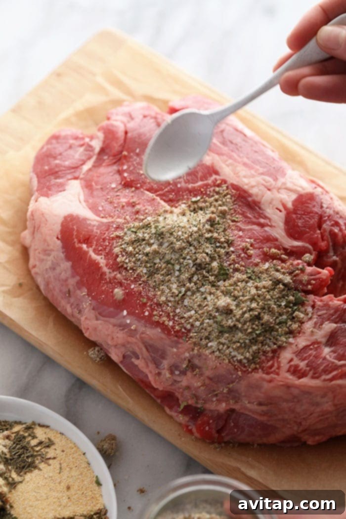 Seasoning a beef roast with the homemade dry rub, ready for cooking