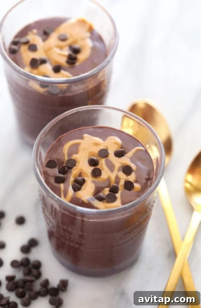 This chocolate protein shake is chocolatey, packed with protein, and the perfect post workout snack or easy breakfast recipe! Two glasses full of creamy chocolate protein shakes, garnished for a dessert-like appeal