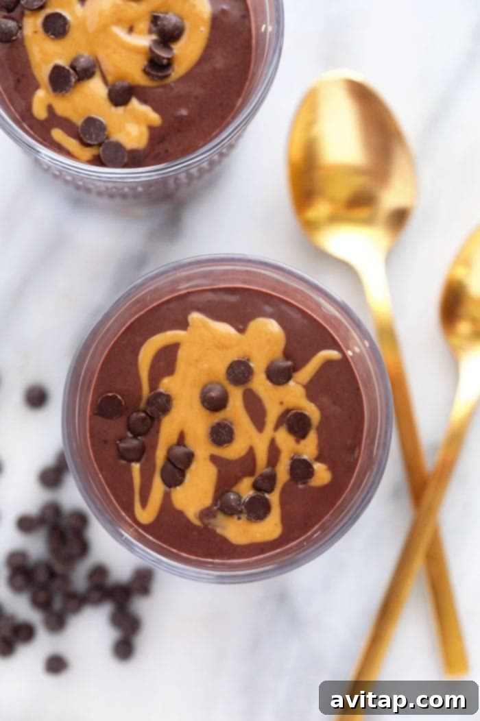 This chocolate protein shake is chocolatey, packed with protein, and the perfect post workout snack or easy breakfast recipe! Rich chocolate protein shake topped with swirls of almond butter and a scattering of chocolate chips
