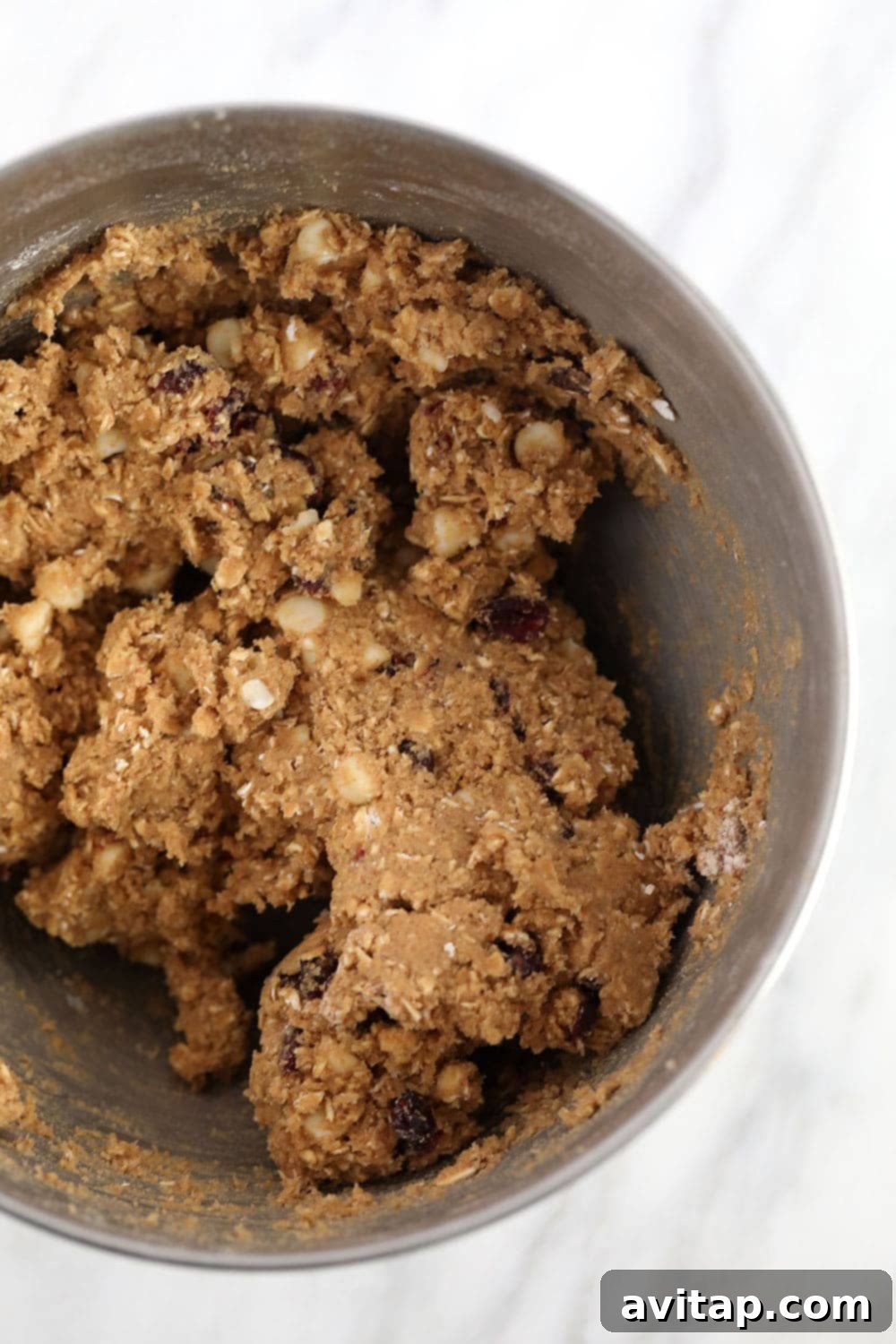 white chocolate cranberry oatmeal cookie batter in a bowl