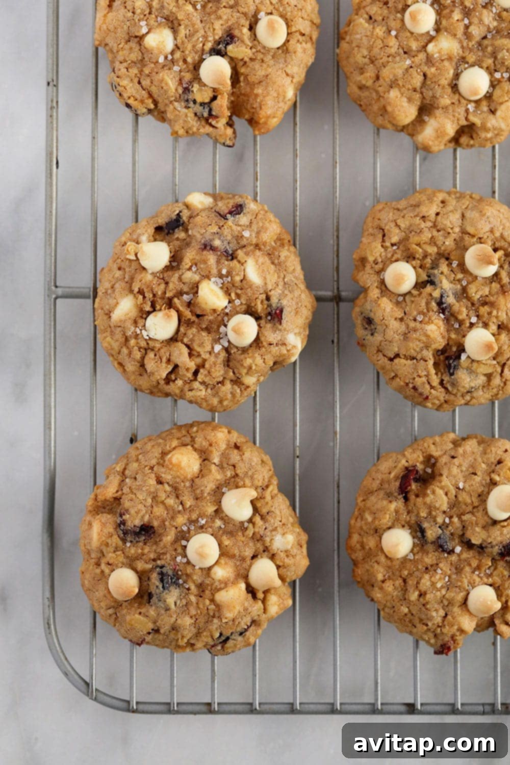 white chocolate cranberry oatmeal cookies on a cooling rack