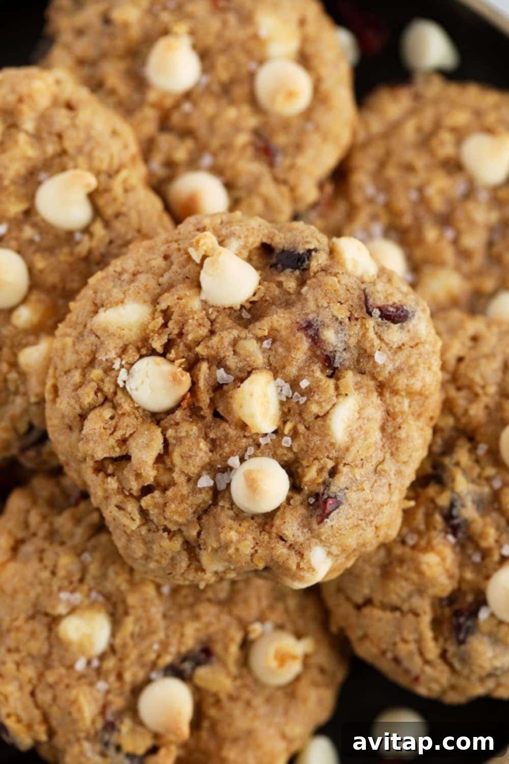 white chocolate cranberry oatmeal cookies topped with white chocolate chips and sea salt