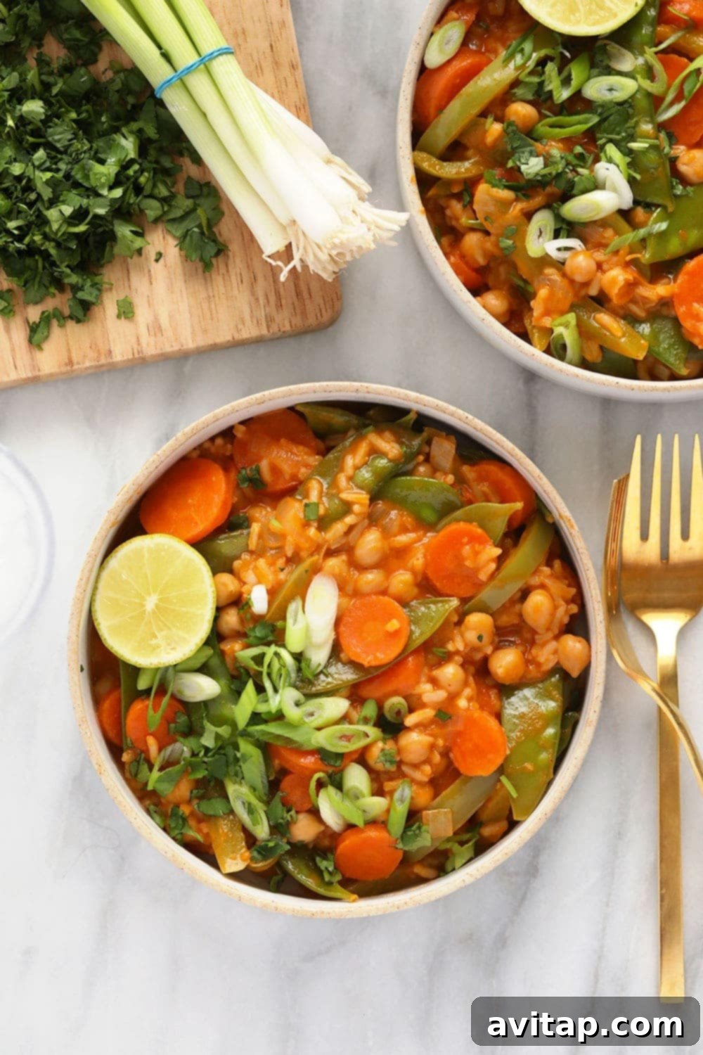 A vibrant bowl of One Pot Vegetarian Thai Curry, brimming with vegetables and a creamy sauce.