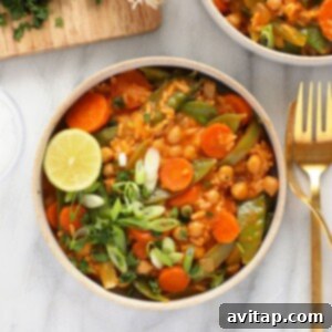 a bowl of Thai chickpea curry with a fork.