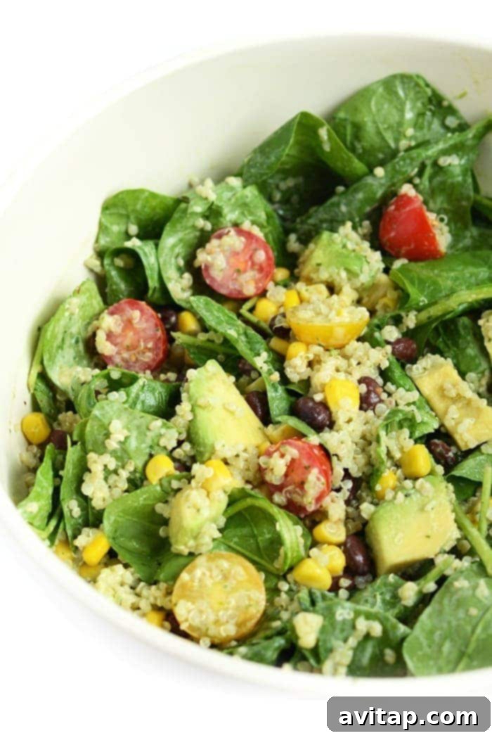 Mason Jar salad poured and mixed in a bowl, showcasing all the colorful ingredients.