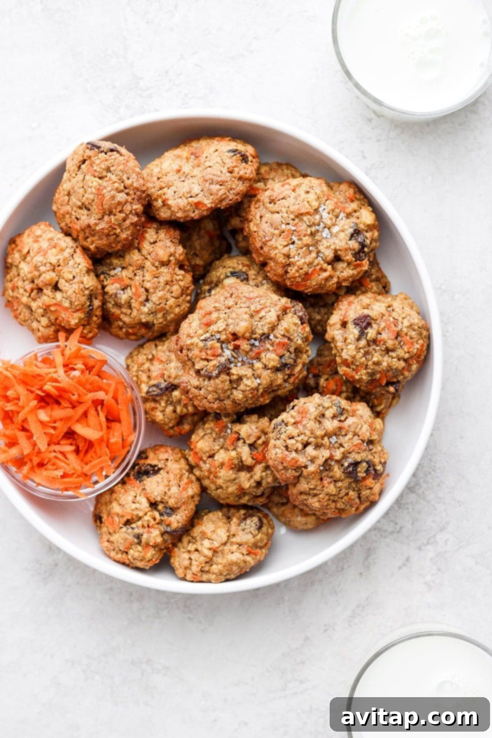 Delicious Oatmeal Carrot Cake Cookies - Your New Favorite Healthy Treat A plate of freshly baked oatmeal carrot cake cookies, garnished with a sprinkle of cinnamon, showcasing their inviting texture and golden-brown edges.