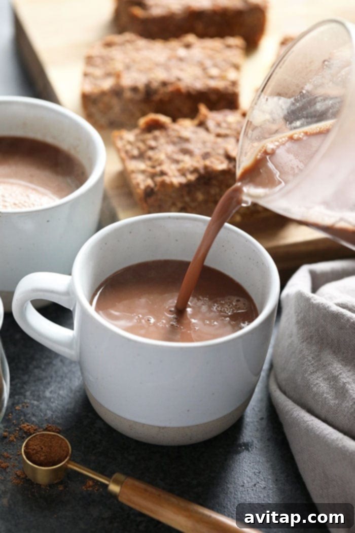 Serving Vegan Chai Hot Chocolate vegan chai hot chocolate being poured into a mug