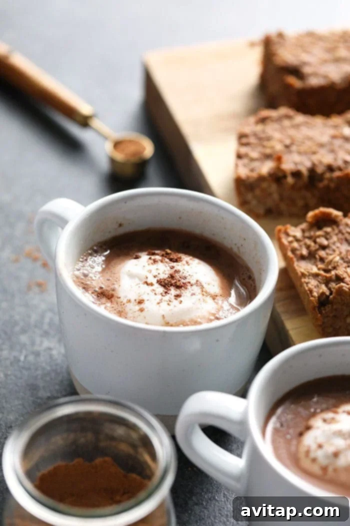 Enjoying Vegan Chai Hot Chocolate vegan chai hot chocolate in a mug topped with vegan whipped cream