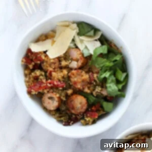 A vibrant quinoa casserole with savory sausage and fresh kale, ready to eat.