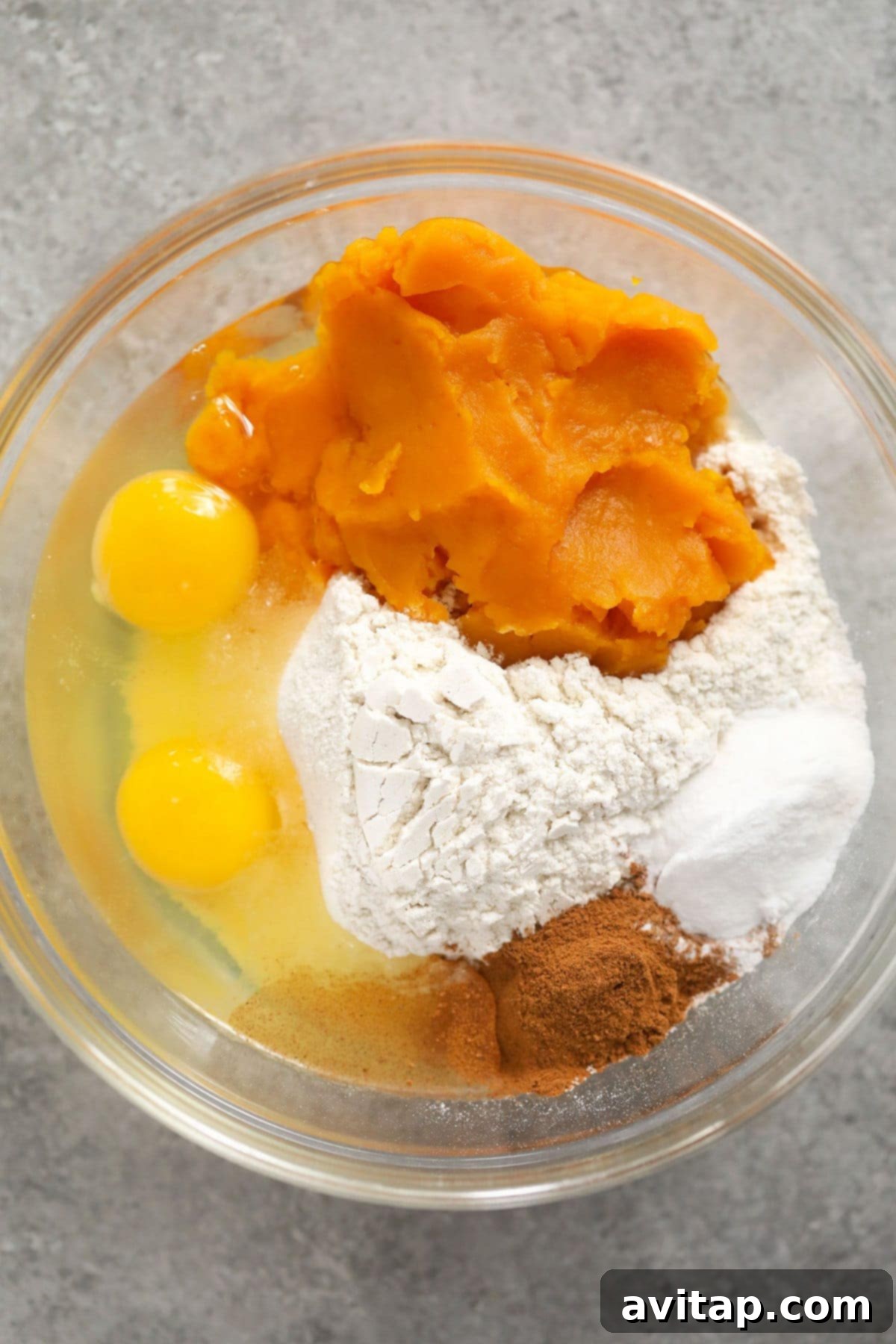 A bowl of creamy pumpkin waffle batter, ready to be poured into the waffle iron.
