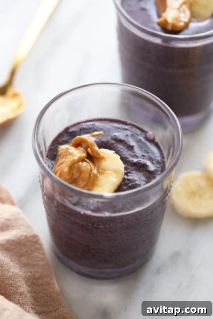 Golden Berry Harvest Smoothie 2 A vibrant Pumpkin Berry Cashew Butter Smoothie served in a tall glass, garnished with fresh berries.