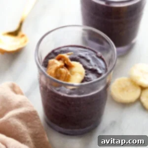 Golden Berry Harvest Smoothie 5 Two glasses of blueberry chia pudding with bananas, depicting a smoothie or healthy drink.