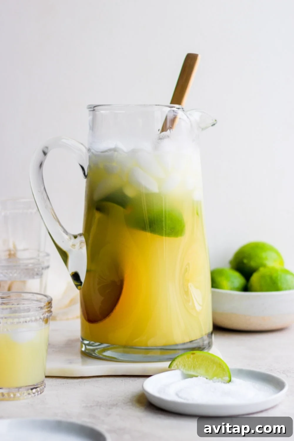 A large pitcher filled with freshly made skinny margarita, ready for serving.