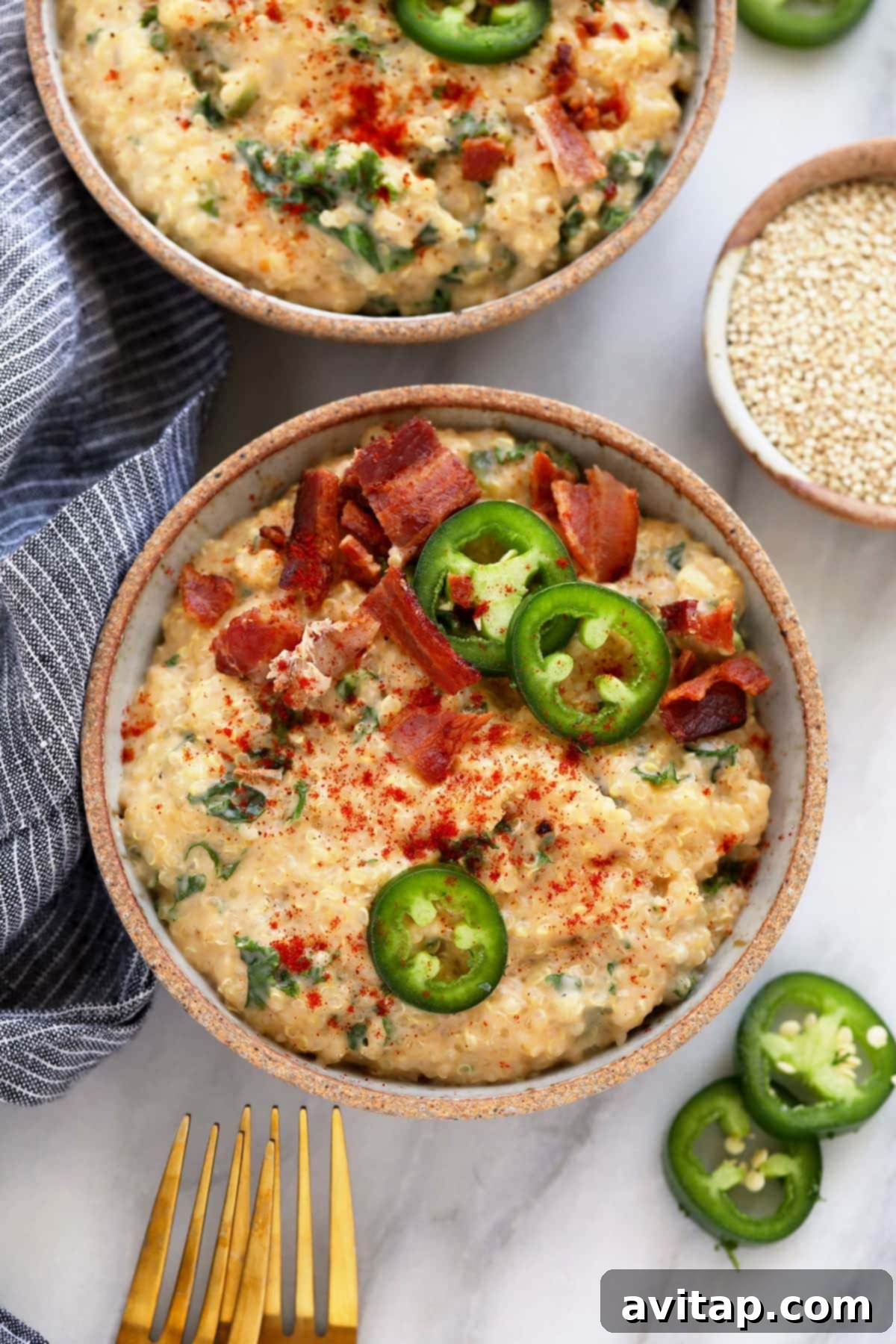quinoa mac and cheese in a dish topped with jalapenos and bacon