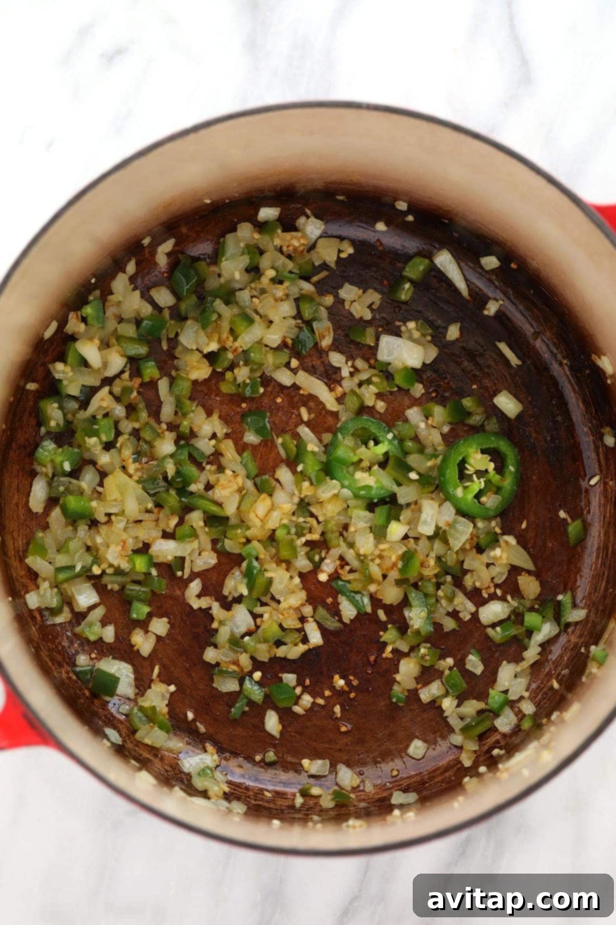 jalapeños, onions and garlic sautéing in a dutch oven