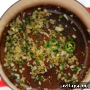 A pan with onions and green peppers in it.