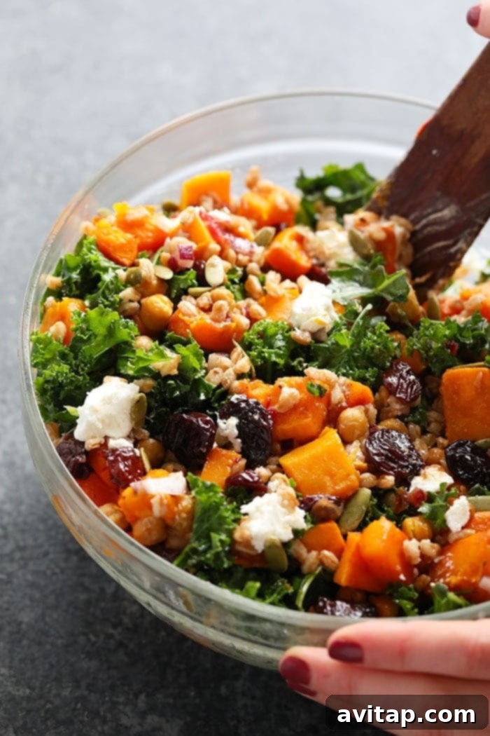 A hearty bowl of Farro Salad with Kale and Butternut Squash, garnished and ready to serve.
