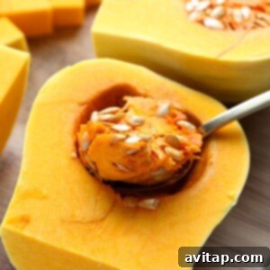 Butternut squash being cleaned and prepared on a cutting board.