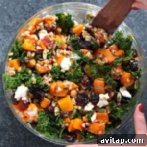 A top-down view of a vibrant Farro Salad with Kale and Butternut Squash in a rustic bowl.