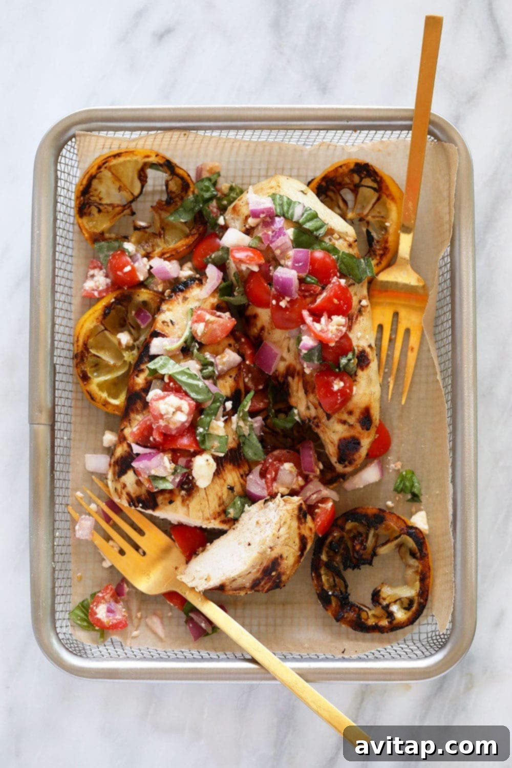 Zesty Grilled Greek Chicken 7 Grilled lemon chicken with Greek salad in a basket.