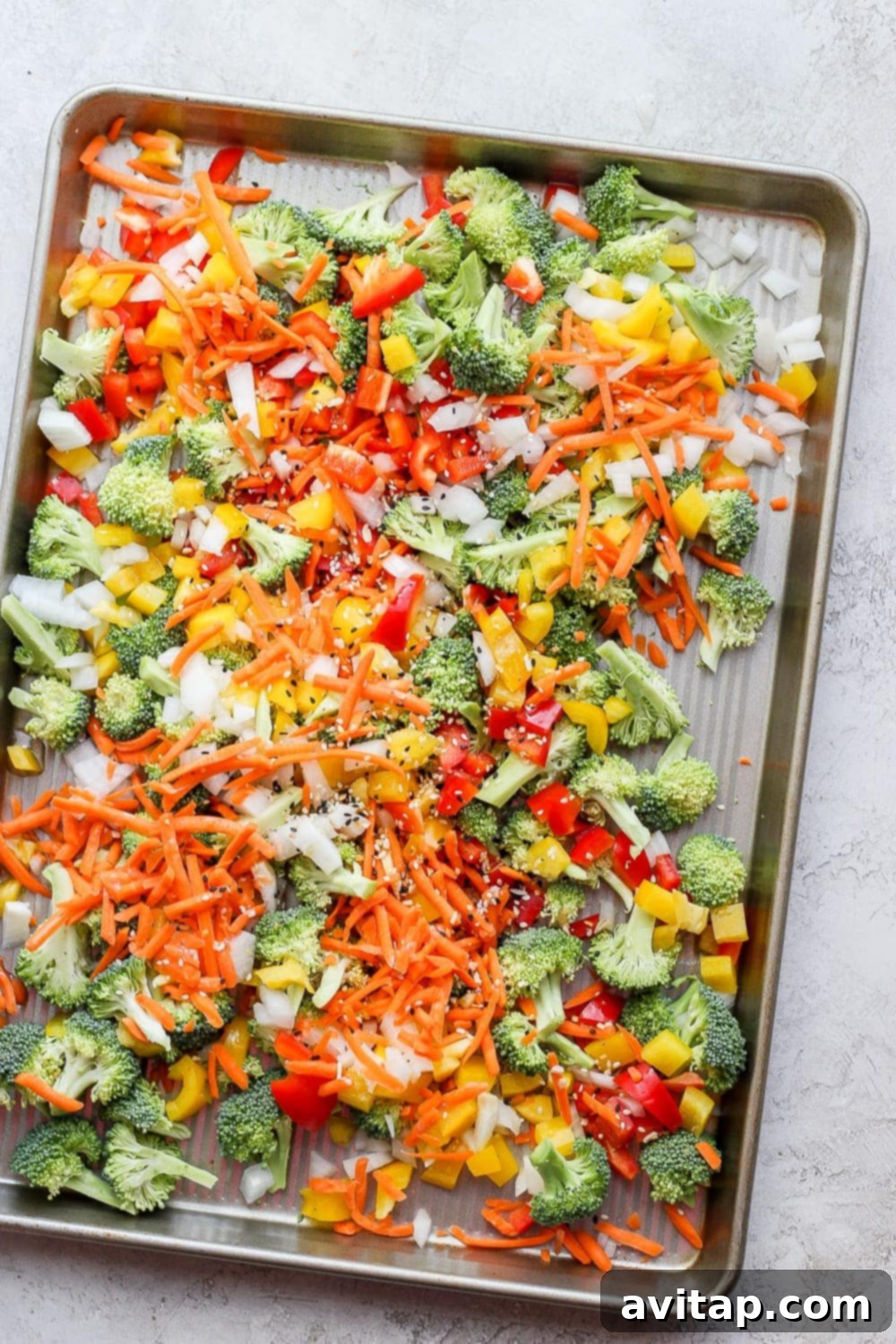 Chopped vegetables for sheet pan salmon stir fry ready to be roasted in the oven