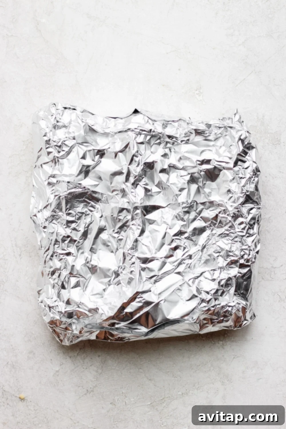 foil pack closed up with corn on the cob inside it