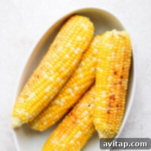 4 ears of corn in a bowl after being grilled