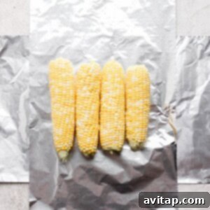 Grilled corn wrapped in foil.
