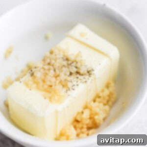 a white bowl with a piece of butter.