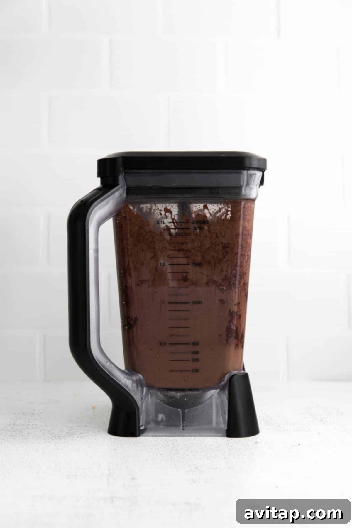 A perfectly blended chocolate peanut butter banana smoothie swirling inside a high-speed blender, showcasing its smooth and creamy texture.