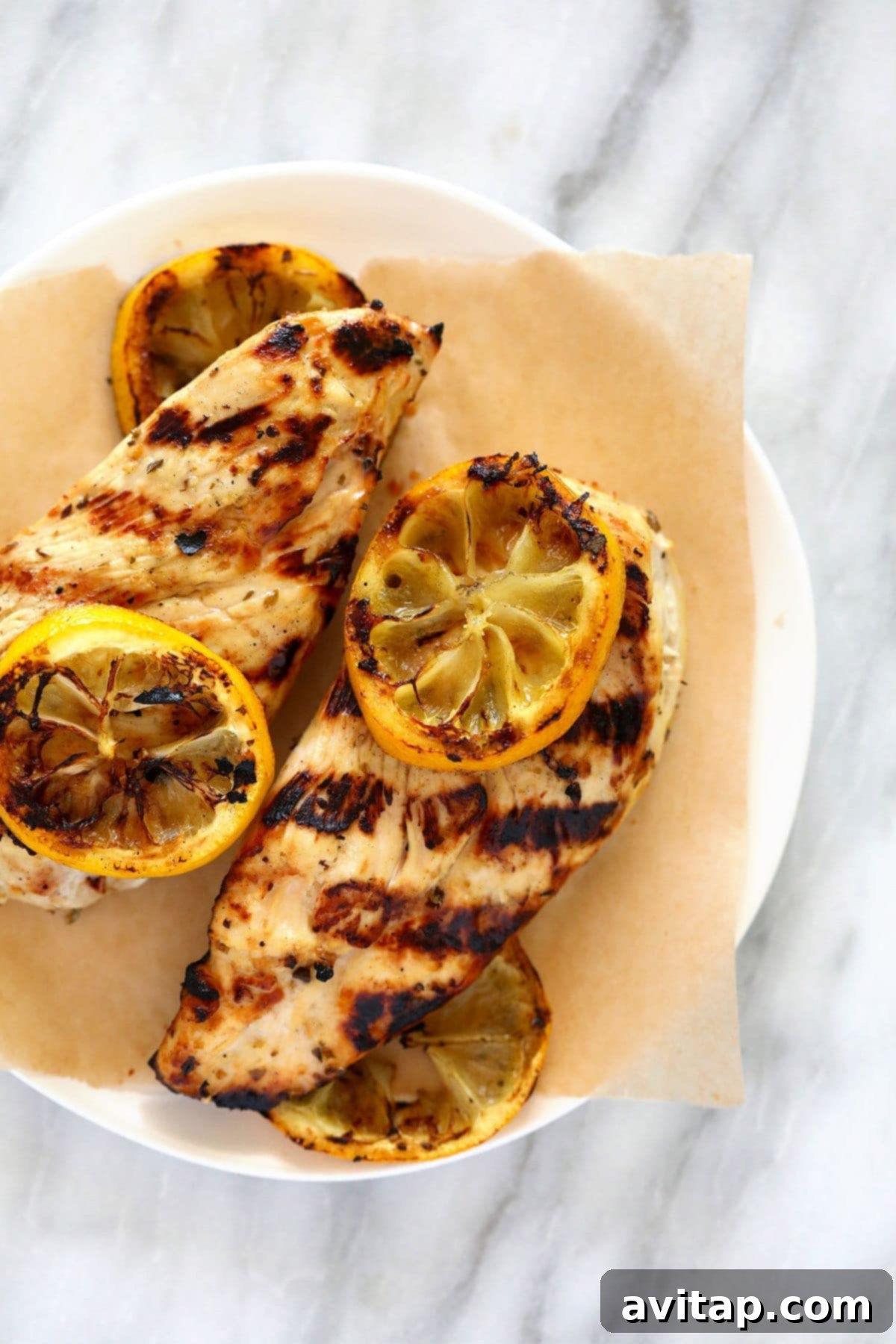 Effortlessly Delicious Greek Chicken Marinade 2 Grilled Greek chicken served on a plate with fresh herbs