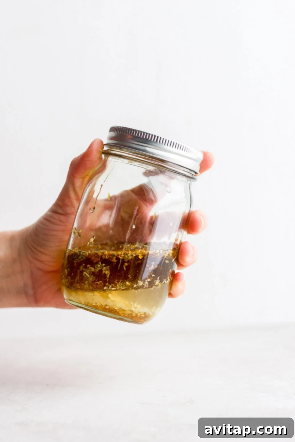 Effortless Greek Chicken Marinade 3 Greek chicken marinade prepared in a clear Mason jar
