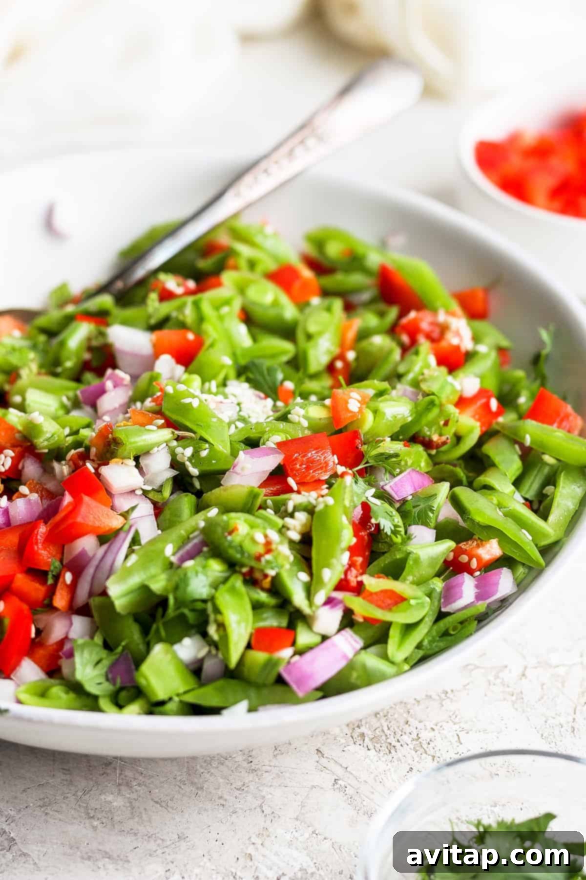 Zesty Ginger Pea Salad 8 A top-down view of ginger pea salad in a stylish bowl, highlighting its crispness and refreshing qualities, topped with sesame seeds.