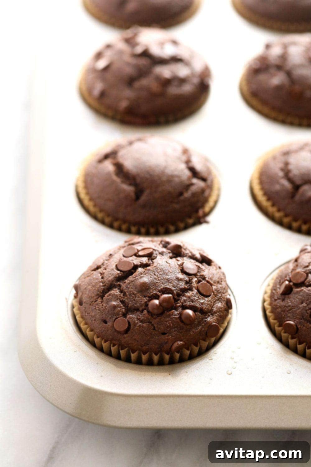 chocolate peanut butter muffins baking in a muffin tin
