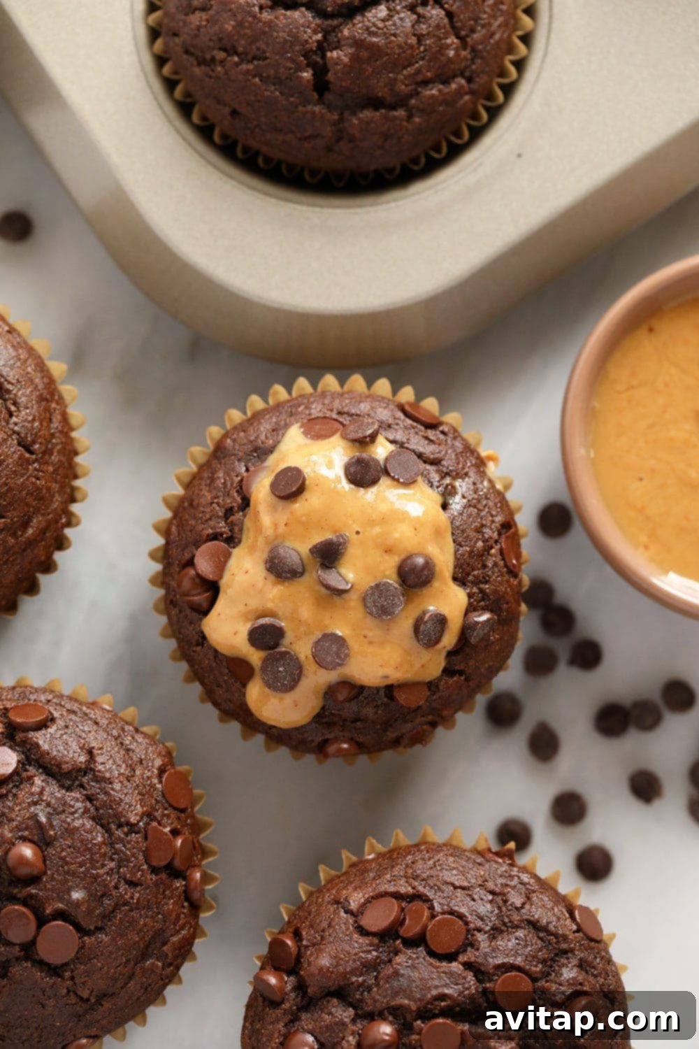 muffins with peanut butter drizzle and chocolate chips