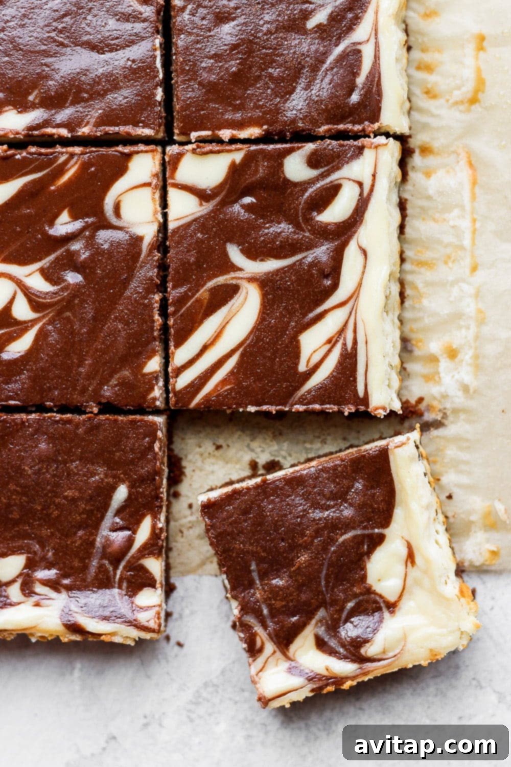 Beautifully swirled chocolate chai Greek yogurt cheesecake bars in a baking pan, ready to be served, showcasing rich chocolate and spice notes.