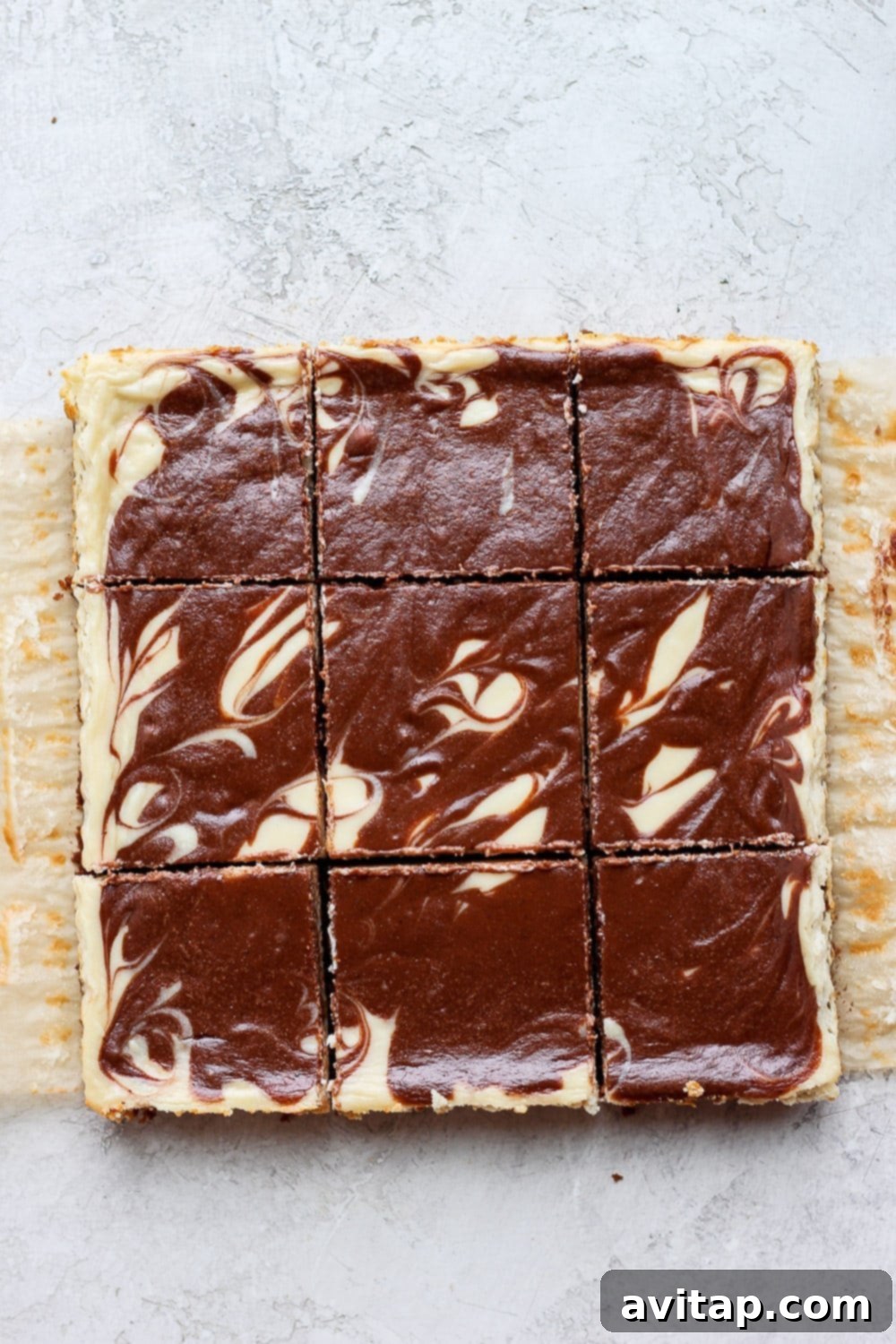 A stunning overhead shot of the finished Greek yogurt cheesecake bars, perfectly sliced and arranged on a white surface, ready to be enjoyed.